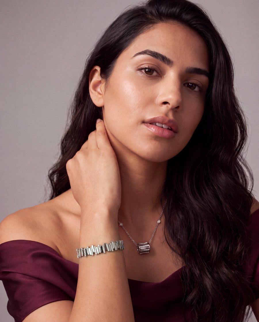 Model wearing a diamond bracelet and pendant, portrait